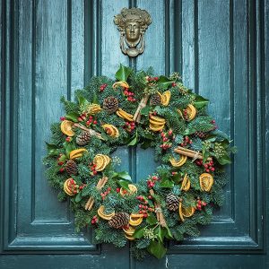 Holiday wreath on green door by Jez Timms https://unsplash.com/@jeztimms