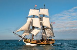 Two-masted Tall Ship Lady Washington with white sails under sail at sea by Bob Habison