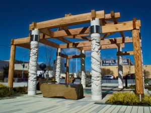 Garden of the Surging Waves Pavilion with carved white columns and wood beams on plaza by Michelle Roth Photography